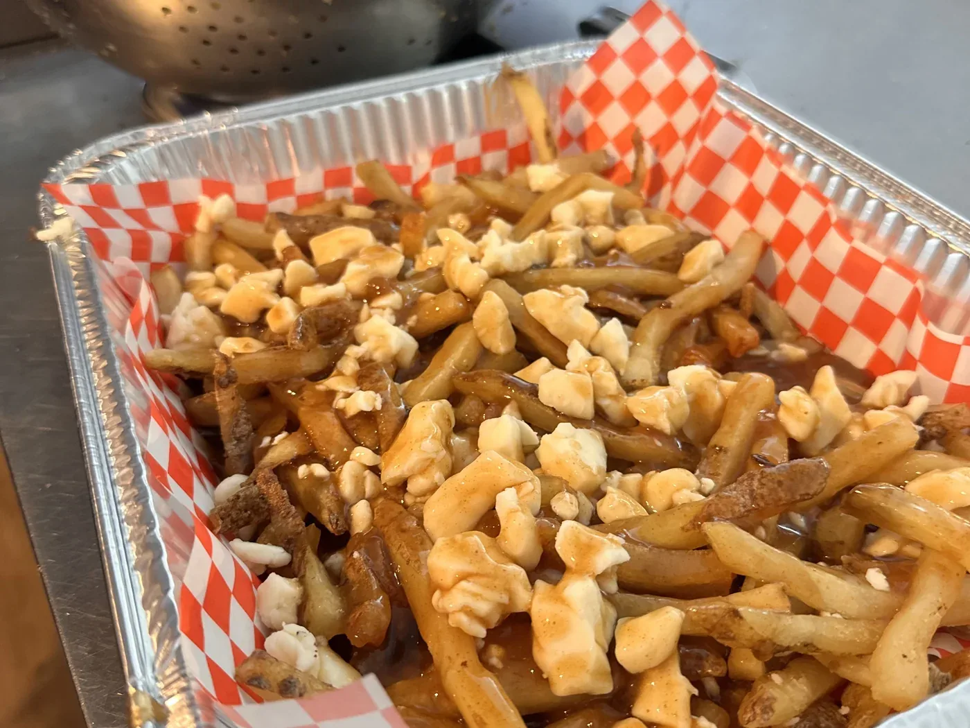 A tray of poutine, ready to go out